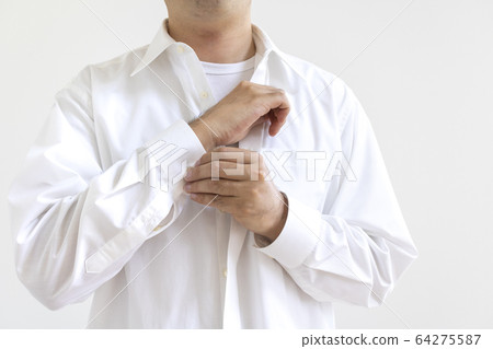 A man changing into a shirt 64275587