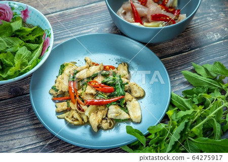 Traditional Thai flavor food.Pad ka prao is a famous food of Thailand people.Spicy sweet basil leaf with garlic chilly and meat stir in the cuisine. 64275917