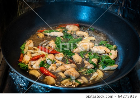 Traditional Thai flavor food.Pad ka prao is a famous food of Thailand people.Spicy sweet basil leaf with garlic chilly and meat stir in the cuisine. 64275919