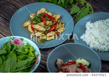 Traditional Thai flavor food.Pad ka prao is a famous food of Thailand people.Spicy sweet basil leaf with garlic chilly and meat stir in the cuisine. Traditional Thai flavor food.Pad ka prao is a famous food of Thailand people.Spicy sweet basil leaf with garlic chilly and meat stir in the cuisine. 64275921