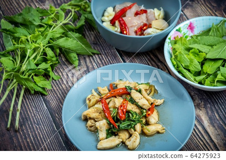Traditional Thai flavor food.Pad ka prao is a famous food of Thailand people.Spicy sweet basil leaf with garlic chilly and meat stir in the cuisine. 64275923