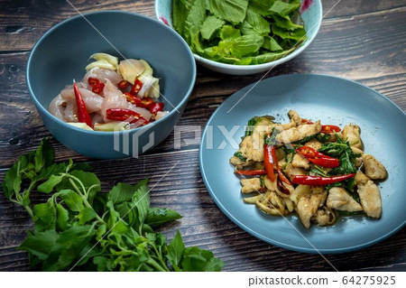 Traditional Thai flavor food.Pad ka prao is a famous food of Thailand people.Spicy sweet basil leaf with garlic chilly and meat stir in the cuisine. 64275925