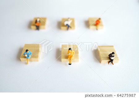 Social distancing. Miniature people stay apart to 64275987