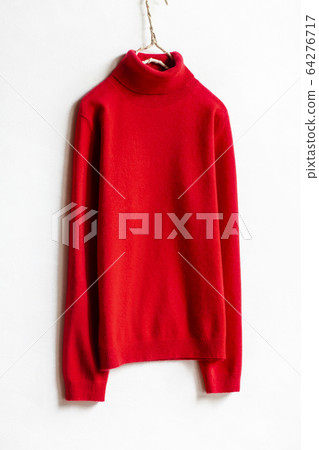 Close up of red turtle sweater on hanger with white background 64276717