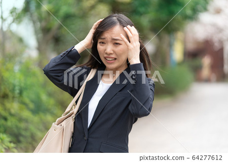 Young woman depressed while going out Young woman depressed while going out 64277612