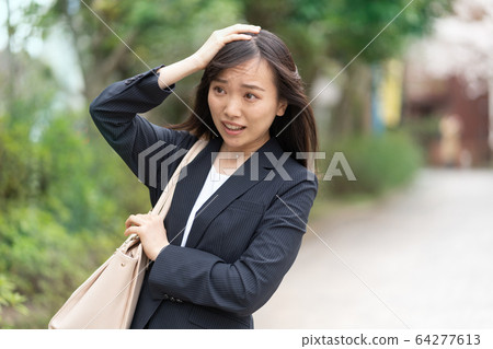 Young woman depressed while going out 64277613