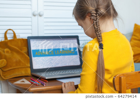 Cute little girl learning at home. Child using laptop Cute little girl learning at home. Child using laptop 64279414