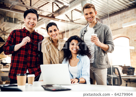 Joyful business people using laptop in modern office 64279904