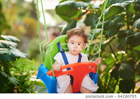 Portrait of baby girl on swings Portrait of baby girl on swings 64280705