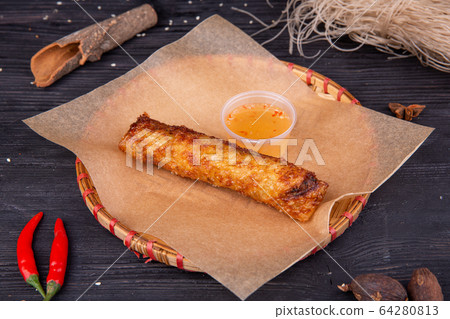 Fried pancake with vegetables, served with honey and pepper 64280813