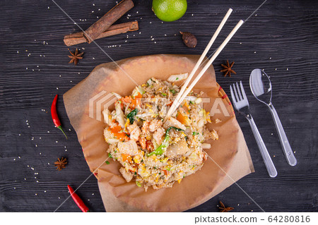 Rice with vegetables, chicken pieces, greens and sesame seeds 64280816