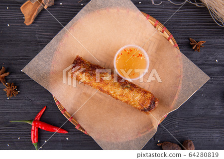 Fried pancake with vegetables, served with honey and pepper 64280819