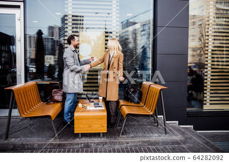 Handsome man smiling at his business partner Handsome man smiling at his business partner 64282092
