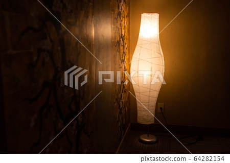 Lamp on wall with cherry blossom paint 64282154