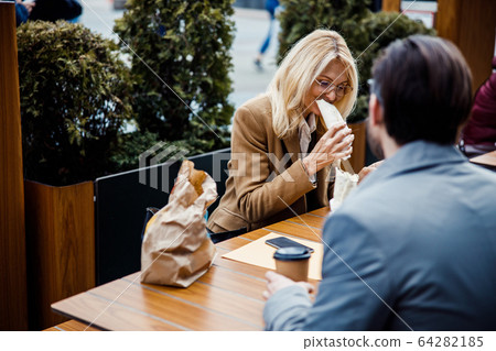 Smiling beautiful lady enjoying her tortilla wrap Smiling beautiful lady enjoying her tortilla wrap 64282185