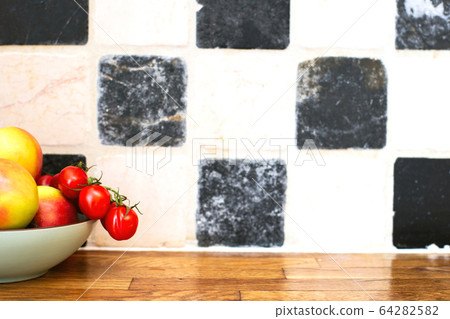 fruit and vegetables on the kitchen top near tiled wall, tomatoes and apples, cozy design fruit and vegetables on the kitchen top near tiled wall, tomatoes and apples, cozy design 64282582