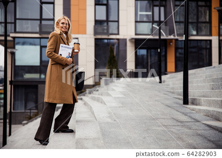 Elegant Caucasian female smiling at the camera Elegant Caucasian female smiling at the camera 64282903
