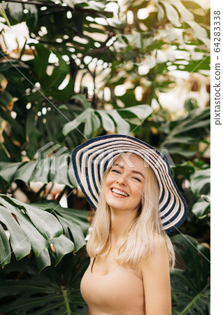 Blonde woman in sun hat Blonde woman in sun hat 64283338