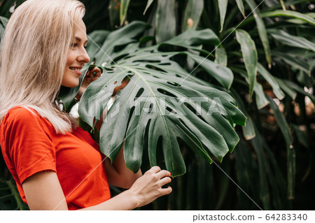 Blonde woman in tropical forest Blonde woman in tropical forest 64283340