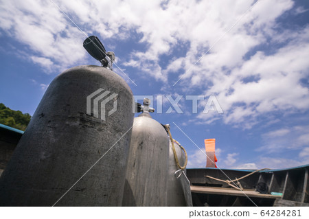 A three oxygen tanks for scuba diving with blue 64284281