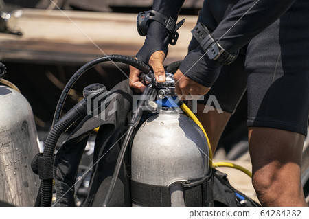 A scuba man preparing about oxygen tank and 64284282