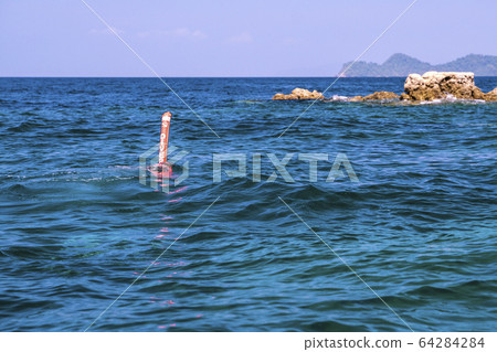 A scuba diving call sausage floating on the sea 64284284