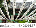 Rows of white lanterns in temple 64284487