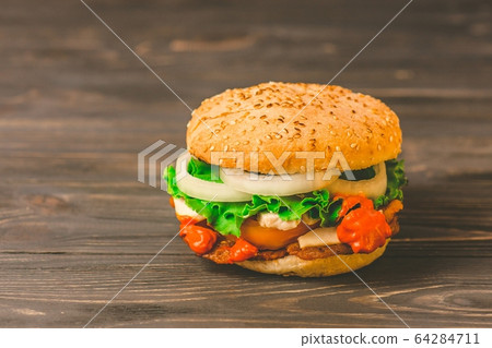 Homemade burger on dark rustic wooden background Homemade burger on dark rustic wooden background 64284711
