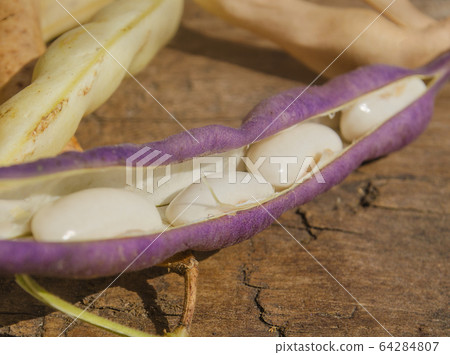 Lima beans on wooden table 64284807