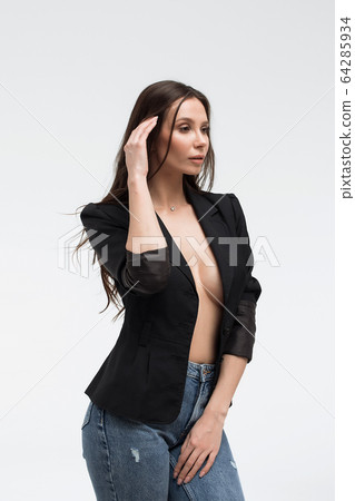 Provocative woman in black suit on naked body Provocative woman in black suit on naked body 64285934