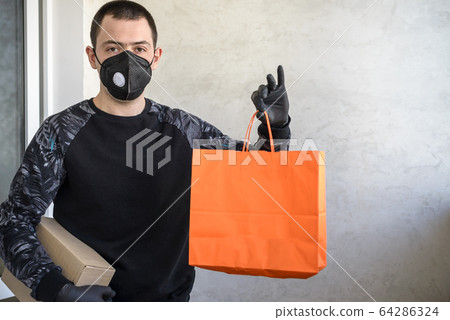 Delivery man holding paper bag with food on white 64286324