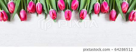 Beautiful pink tulips on wooden background 64286512