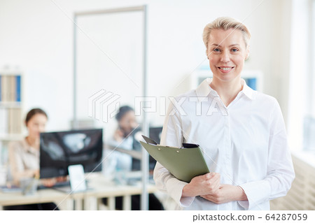 Successful Businesswoman Posing with Employees Successful Businesswoman Posing with Employees 64287059