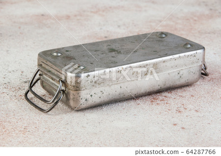 Old Soviet brass syringe sterilizer on concrete Old Soviet brass syringe sterilizer on concrete 64287766