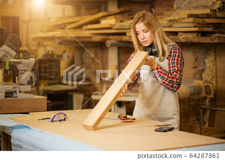 beautiful caucasian woman carpenter deals with handicraft 64287861