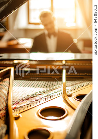 close-up photo of piano, man play on it 64288012
