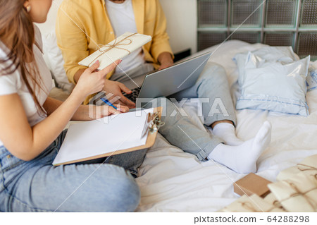 beautiful caucasian couple sorting letters at home 64288298