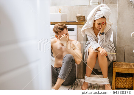 young couple clouded by negative pregnancy test 64288378