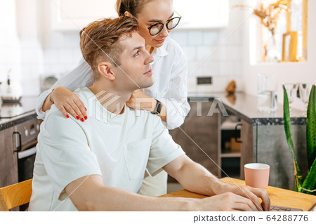 caring wife supporting husband, he works on freelance caring wife supporting husband, he works on freelance 64288776