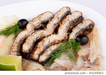 Fish plate with red fish, canned food and halibut, served with lime and dill and olives 64289063