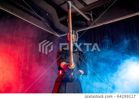 kendo warrior in traditional dress on smoky background 64289117