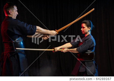 two kendo fighters practicing kenjutsu, Japanese martial art using swords 64289167