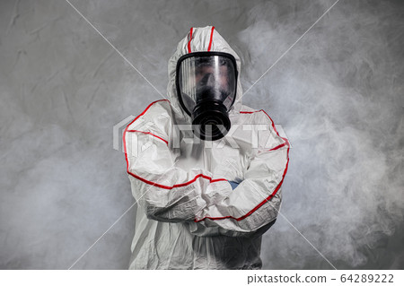 male in protective hazmat suit and gas-mask. pathogen respiratory quarantine coronavirus concept 64289222