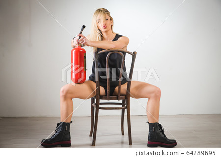 young woman in a welding glasses holding fire 64289695