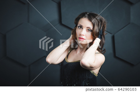 Pretty female magician dressed in performer Pretty female magician dressed in performer 64290103