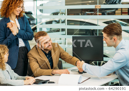 consultant and customers in dealership 64290191