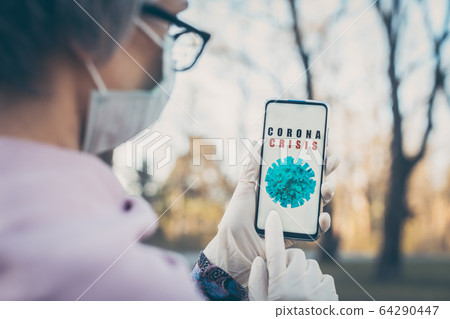 Senior woman using Coronavirus tracking app on her phone Senior woman using Coronavirus tracking app on her phone 64290447