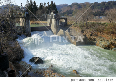 Thawing water flowing through the sluice gate of Nunosawa River Tadami Town, Fukushima Prefecture 64291356