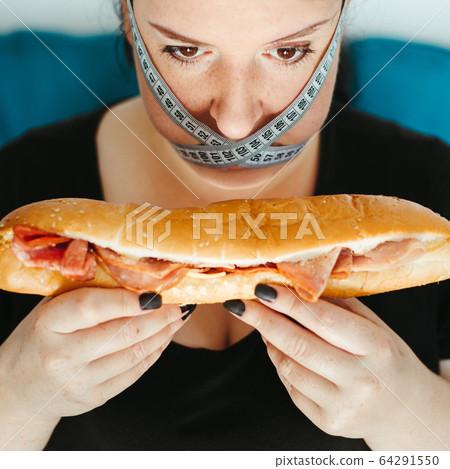 Obese woman with unhealthy food, eating disorder Obese woman with unhealthy food, eating disorder 64291550