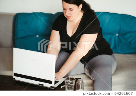 Obese woman reading medical prescription for pills Obese woman reading medical prescription for pills 64291607